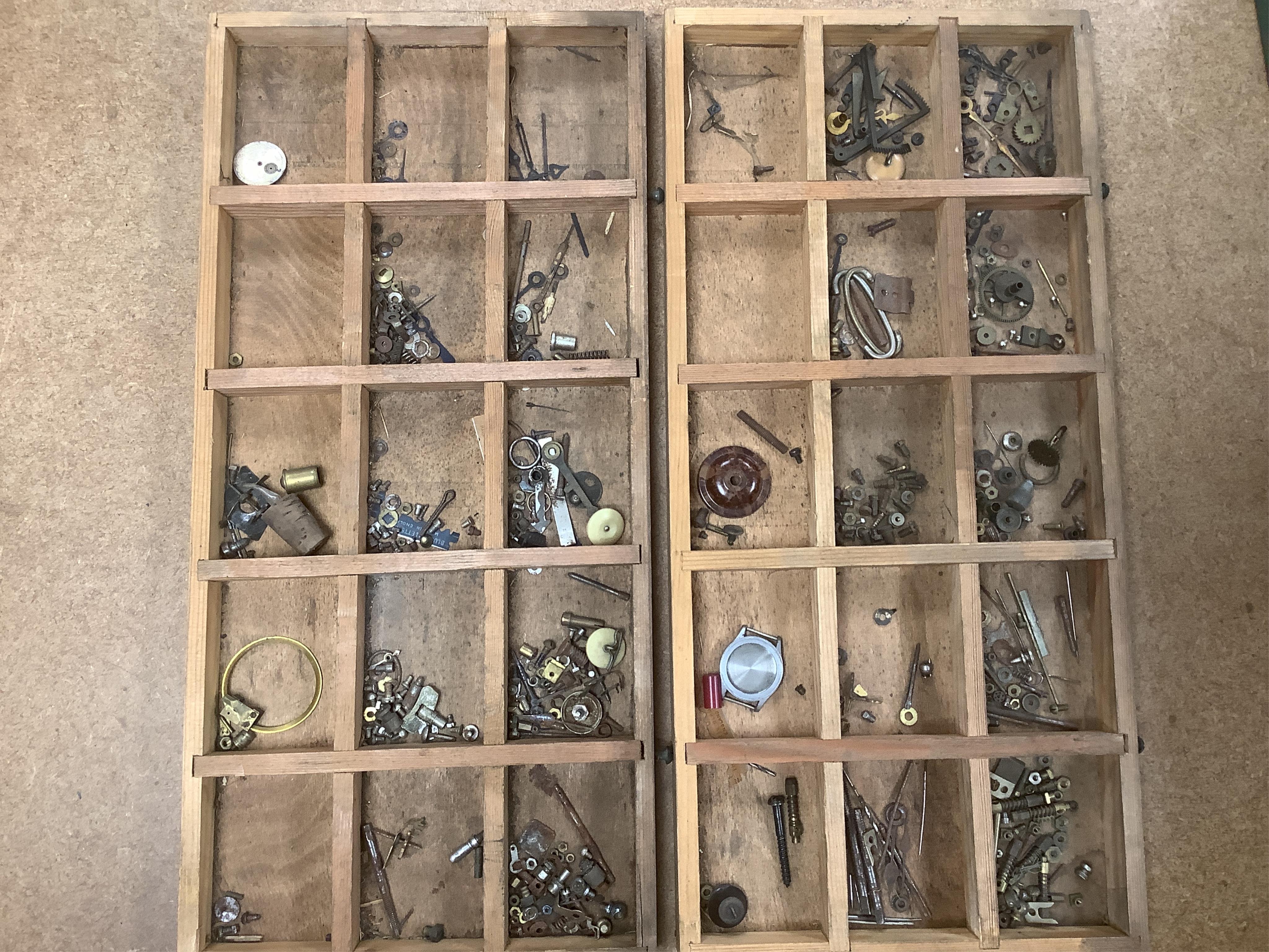 A wooden twelve drawer cabinet containing a collection of watch parts. Condition - cabinet fair to good, watch parts as found